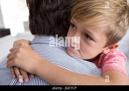 Father and son embracing each other in living room at home Stock Photo