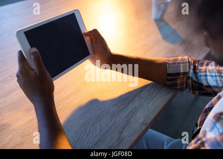 Male executive using digital tablet at his desk in office Stock Photo