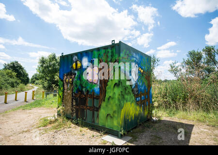 Graffiti in Northamptonshire artwork art hut tin metal coloured colour design designed road Welford Road bushes bush path road sky clouds butterfly Stock Photo