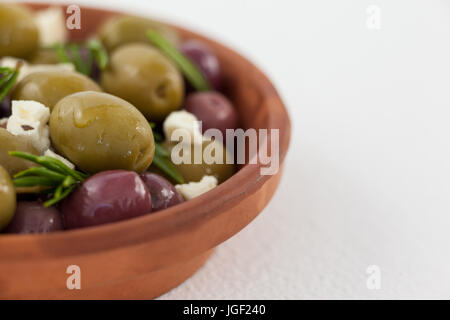 Cropped image of olives with cheese served in bowl on table Stock Photo