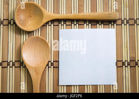 Blank note paper with wooden spoon on wooden background , Cooking concept. Stock Photo