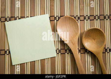 Blank note paper with wooden spoon on wooden background , Cooking concept. Stock Photo