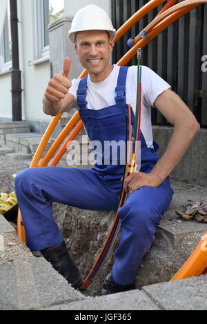 A Worker at Fiber optic broadband construction site Stock Photo