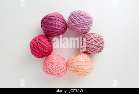 Knitting yarn balls in pink tone. Colored yarn on a white background. Skeins of wool yarn for knitting. Stock Photo