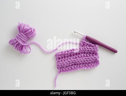 Crochet Hook and Wool. Crochet hook and lilac wool. Stock Photo