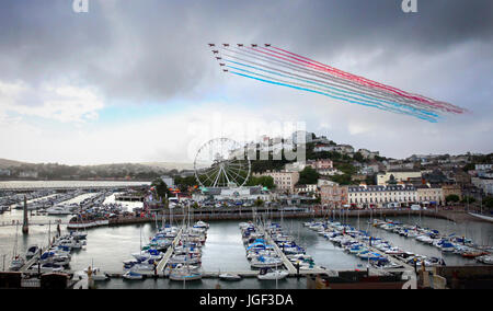 The Red Arrows perform a colourful display over the English Riviera at Torquay, Devon, UK Stock Photo