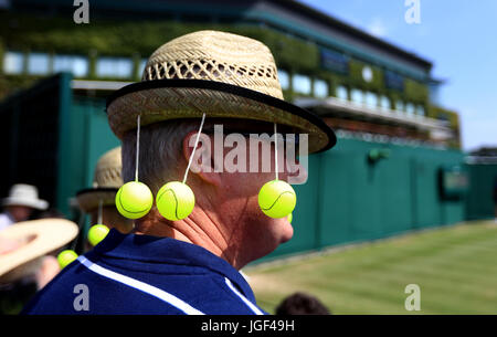 A Spectator wearing a tennis themed hat on day four of the Wimbledon Championships at The All England Lawn Tennis and Croquet Club, Wimbledon. Stock Photo