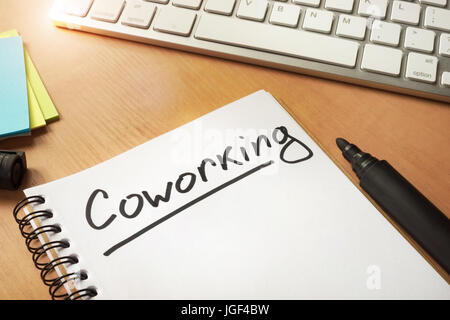 Coworking handwrited on a note. Stock Photo