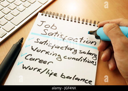 Job satisfaction list written by hand. Stock Photo