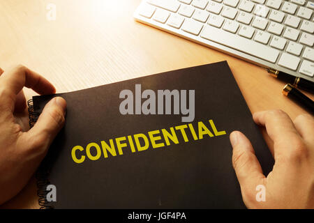 Document with label confidential on a table. Stock Photo