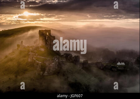 Corfe castle on misty sunrise Stock Photo