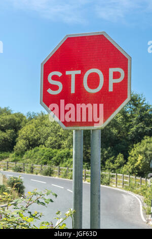 Octagonal red traffic stop sign seen against blue summer sky. Possible metaphor for US government shutdown. Metaphor for 'obey', end of the road. Stock Photo