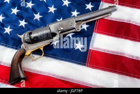 Old western cowboy pistol on flag with room for your type. Stock Photo