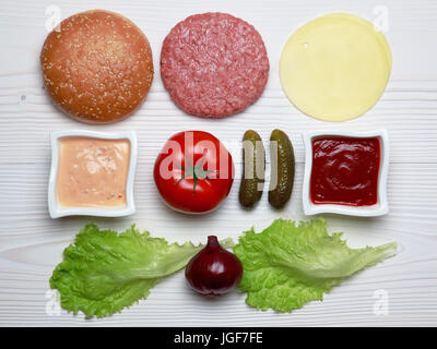 Ingredients for hamburger on white wooden table. Stock Photo