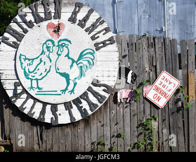 Odd chicken sign on a wooden fence Stock Photo