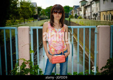 Japanese model posing on a bridge Stock Photo