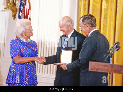 C. Douglas Dillon, American diplomat and politician, who served both as United States Ambassador to France and as the 57th Secretary of the Treasury, center, is awarded the Presidential Medal of Freedom, the highest civilian award of the United States, by US President George H.W. Bush, right, and first lady Barbara Bush, left, in a ceremony in the East Room of the White House in Washington, DC on July 6, 1989.   Credit: Ron Sachs / CNP /MediaPunch Stock Photo