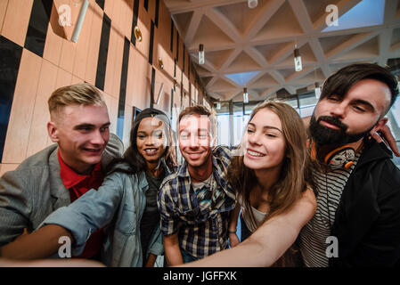Five happy students making selfie. Closeup shot. Students in the big room Stock Photo