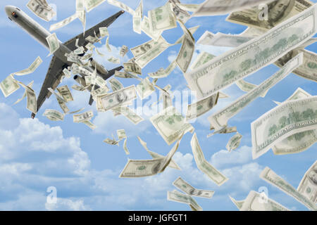 Money falling in sky under airplane Stock Photo