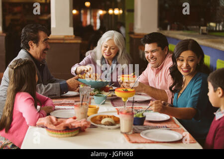 Family enjoying dinner in restaurant Stock Photo