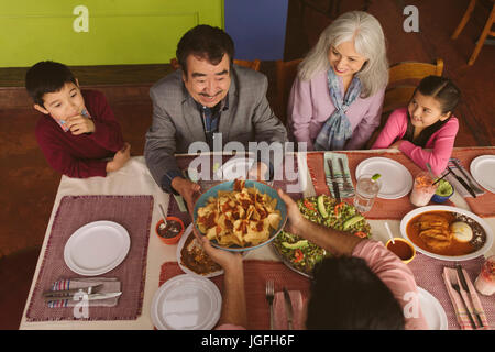 High angle view of family enjoying dinner in restaurant Stock Photo