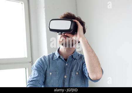 amazed man wearing virtual reality goggles Stock Photo