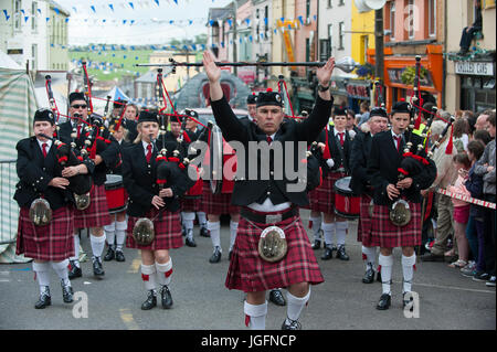 Kilted bagpipers march in the Coronation Parade during Puck Fair in Killorglin. Stock Photo