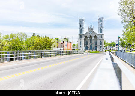 Sainte-Anne-de-la-Perade, Canada - May 29, 2017: Parish of Sainte Anne de la Perade in small town on Chemin du Roy with road on bridge Stock Photo