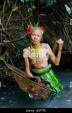 MENTAWAI PEOPLE, WEST SUMATRA, SIBERUT ISLAND, INDONESIA – 16 NOVEMBER 2010: Women Mentawai tribe fishing. Stock Photo