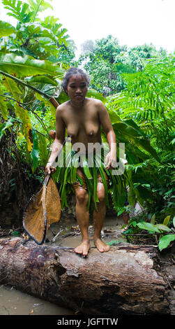 MENTAWAI PEOPLE, WEST SUMATRA, SIBERUT ISLAND, INDONESIA – 16 NOVEMBER 2010: Women Mentawai tribe fishing. Stock Photo