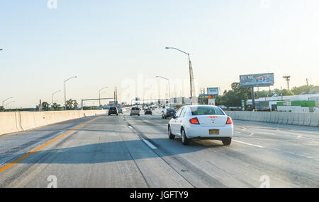 Philadelphia, USA - June 11, 2017: Road on interstate highway 95 with cars and traffic and cityscape or skyline of downtown during sunset Stock Photo