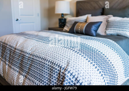 Closeup Of New Bed Comforter With Decorative Pillows Headboard In