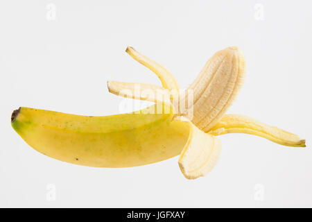 Half peeled banana (Musa acuminata) isolated on white background Stock Photo