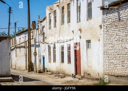 Street with white mud houses in the downtown of Bukhara, Uzbekistan Stock Photo
