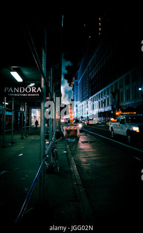 New York streets at night with steam coming out from ground Stock Photo