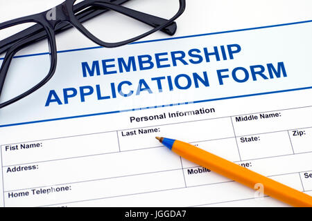 Membership application form with ballpoint pen and glasses. Stock Photo