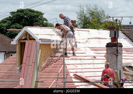 Builders constructing a loft extension on a suburban bungalow in Shepperton Surrey UK Stock Photo