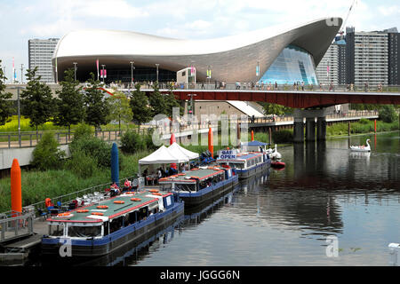 River Lea flowing through the Queen Elizabeth Olympic Park landscape and the Aquatics Centre Stratford, Newham East London England UK    KATHY DEWITT Stock Photo