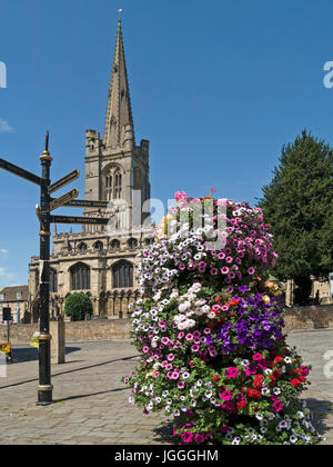 Red Lion Square and All Saints Church with flowers and finger post direction sign, Stamford, Lincolnshire, England, UK Stock Photo