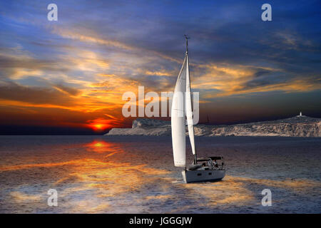 Sailboat Sailing on the Mediterranean sea during the sunset Stock Photo
