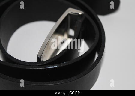 Isolated photo of men's black leather belt on white background Stock Photo