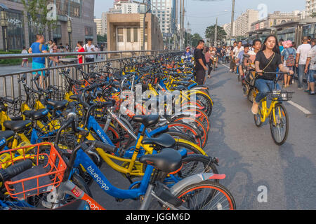 People ride shared bikes in Beijing, China. 07-Jul-2017 Stock Photo
