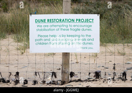 Dune restoration Project sign and fence linen with post at the popular resort beach at Daymer Bay in Cornwall Stock Photo