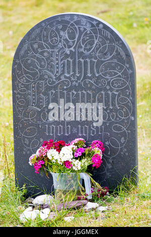 Sir John Betjeman's grave stone with flowers at the base at St Enadoc's chapel Stock Photo