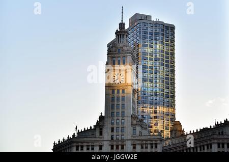 With the sun setting behind the Chicago landmark Wrigley Building, it created a reflection on the landmark clock. Chicago, Illinois, USA. Stock Photo