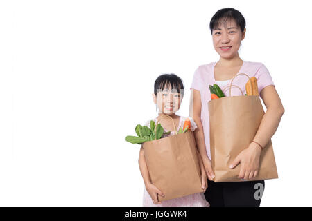 Asian Woman and daughter carrying groceries in isolated White Background Stock Photo