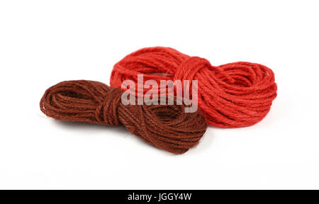 Two small coil skeins of natural colorful multicolor jute twine rope, red and brown,  isolated on white background, close up, high angle view Stock Photo