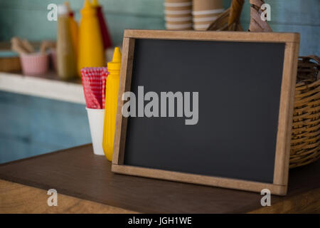 Close up of writing slate on wooden table in food truck Stock Photo