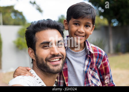 Close up portrait of happy father and son in yard Stock Photo