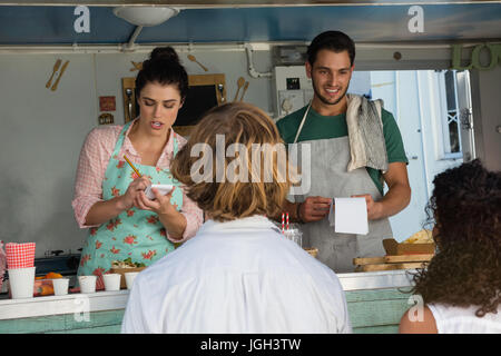 Owner taking order from customer at food truck Stock Photo